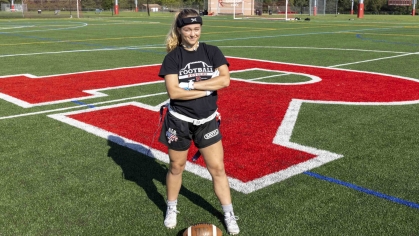 Allison Gandlin, a sophomore at Rutgers University-New Brunswick, stands on a sports field on Busch campus.